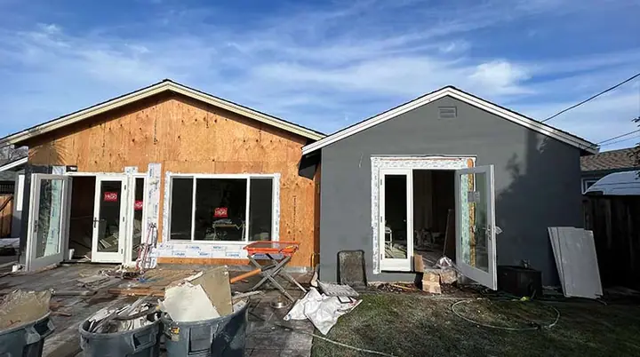 Converted ADU with new windows and siding beside the main house
