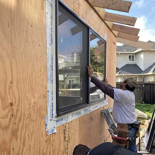 Clever crew installing a window in the addition's new framing