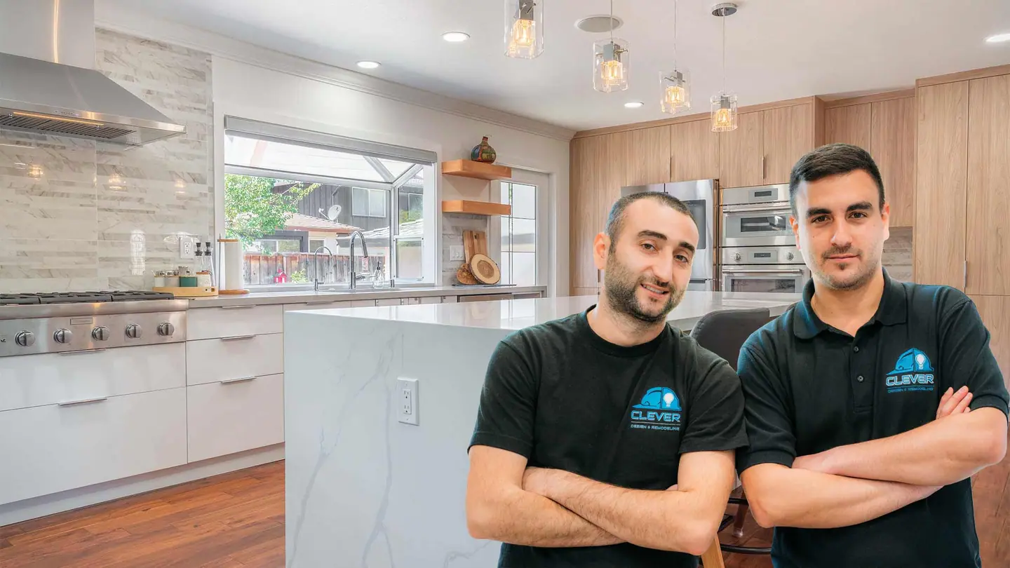 Two members of the Clever Design & Remodeling team in a finished kitchen