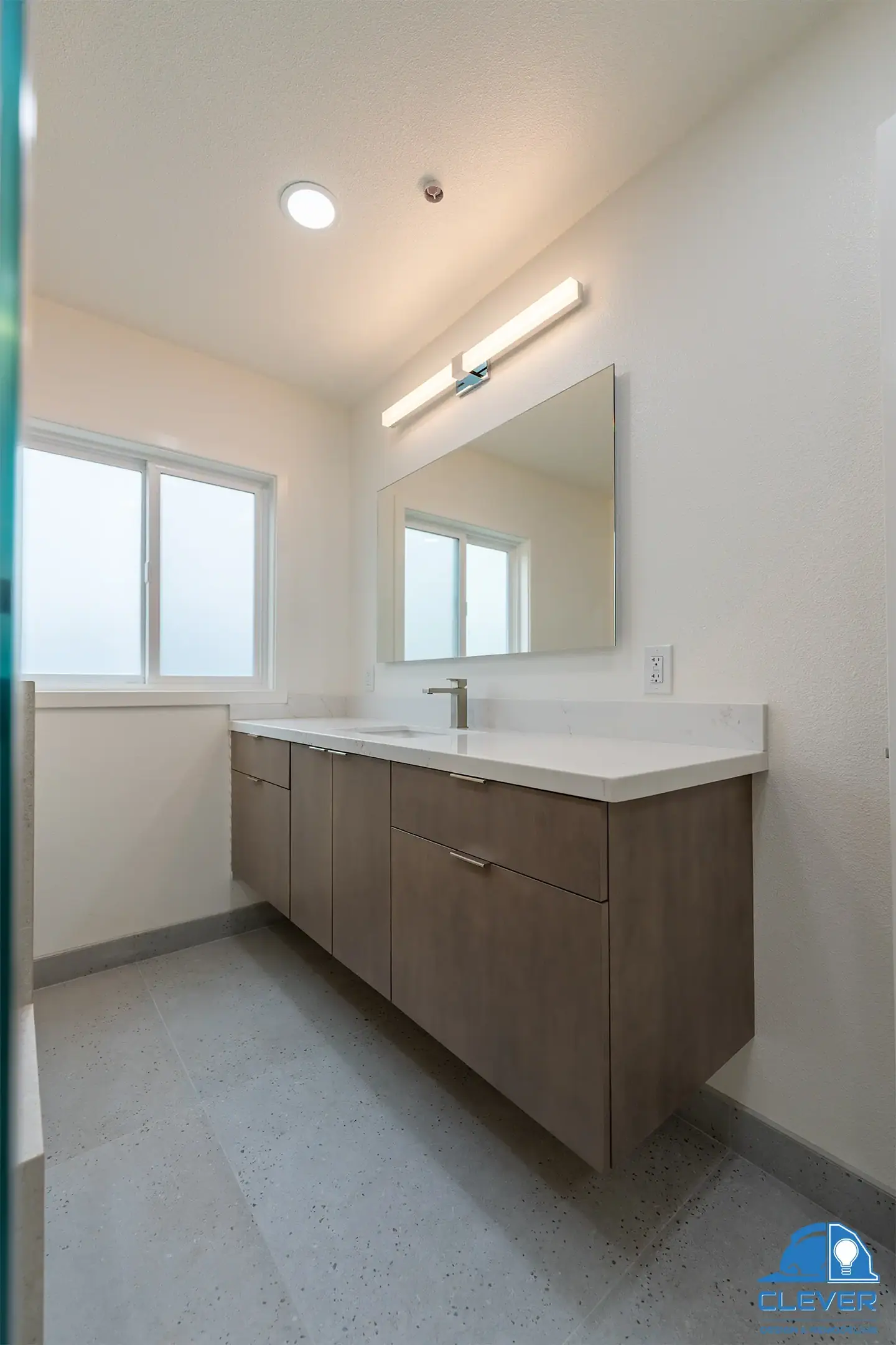 Floating wood vanity in the remodeled bathroom