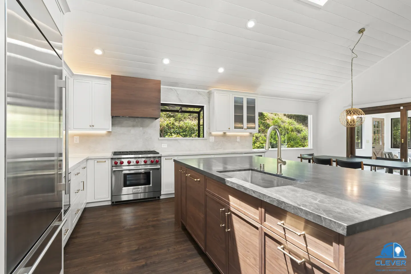 Walnut island with a prep sink beside a built-in stainless refrigerator and a pro-style range, kitchen and bath remodel in Los Gatos, CA