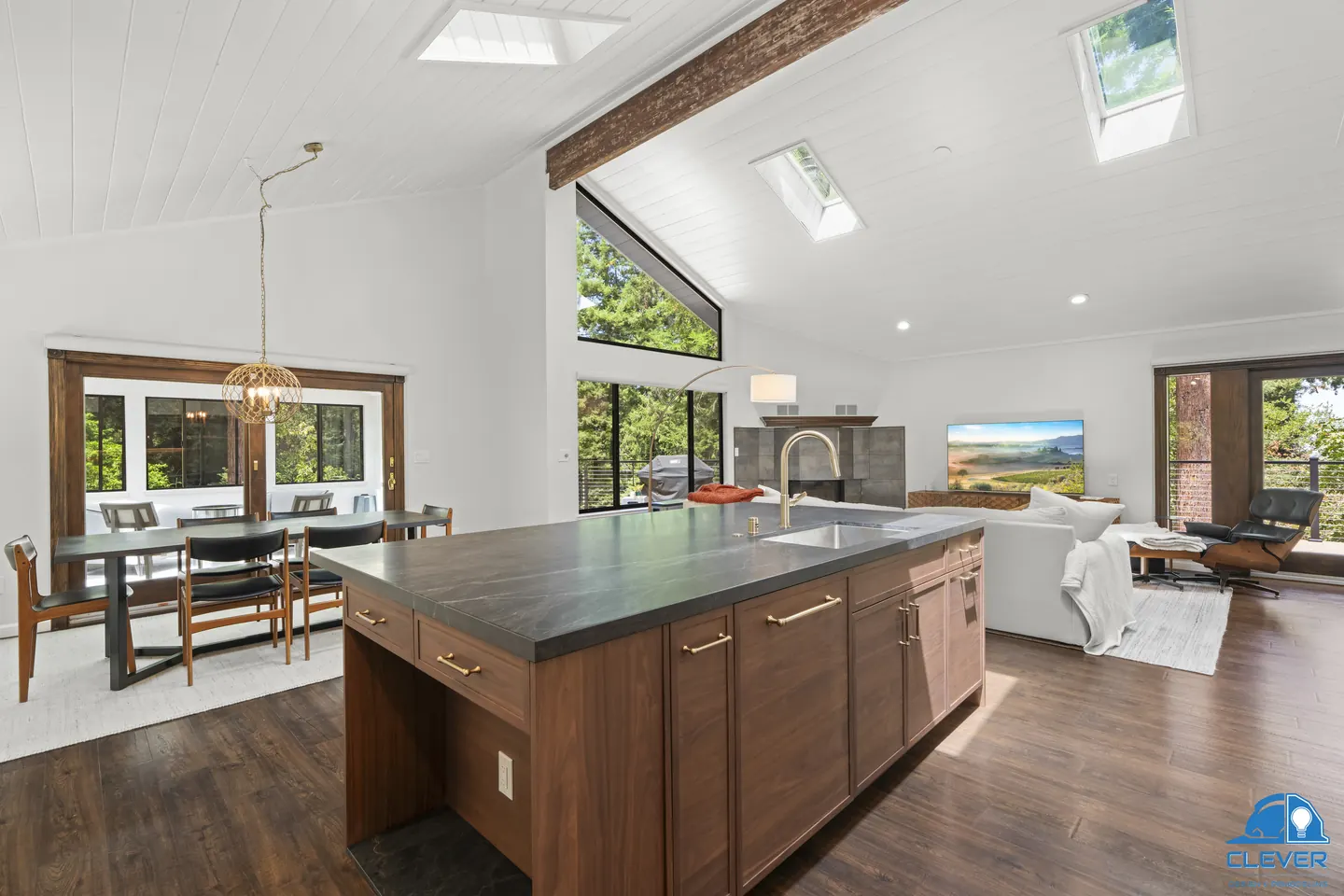 Walnut island opening to the dining and living rooms under a vaulted ceiling with a wood beam, kitchen and bath remodel in Los Gatos, CA