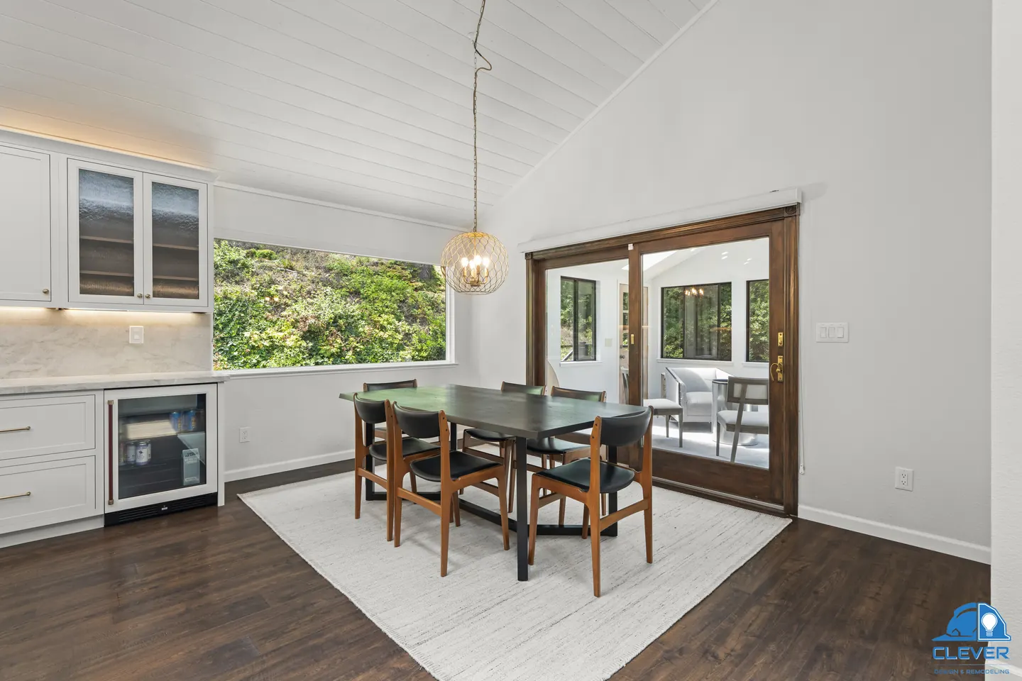 Dining area with a brass globe pendant, a wine fridge and French doors to the deck, kitchen and bath remodel in Los Gatos, CA