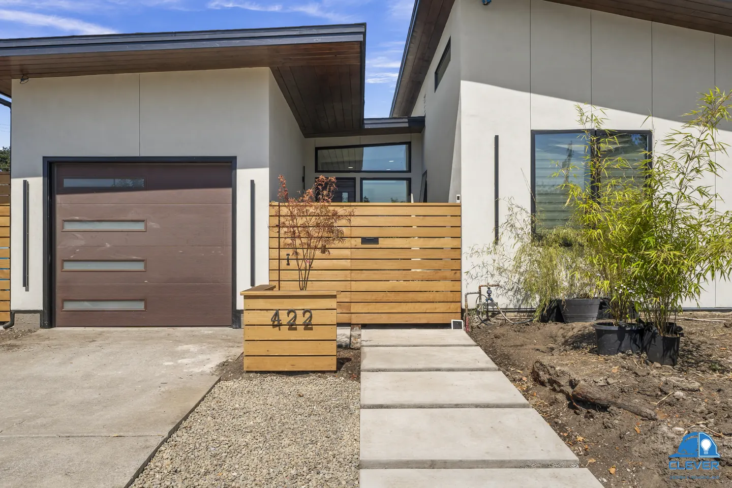 Entry walk of large concrete pavers beside the cedar gate and address planter, modern home in Santa Clara, CA